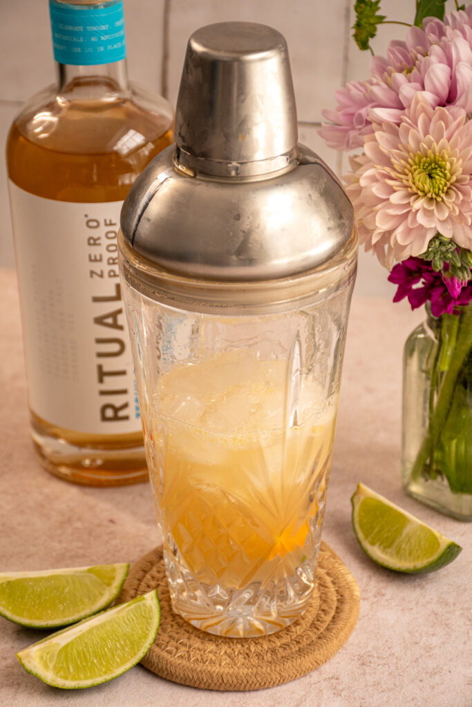 A glass shaker with non alcoholic margarita freshly shaken with ice.