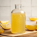 Jar with yellow colored lemon ginger shrub.