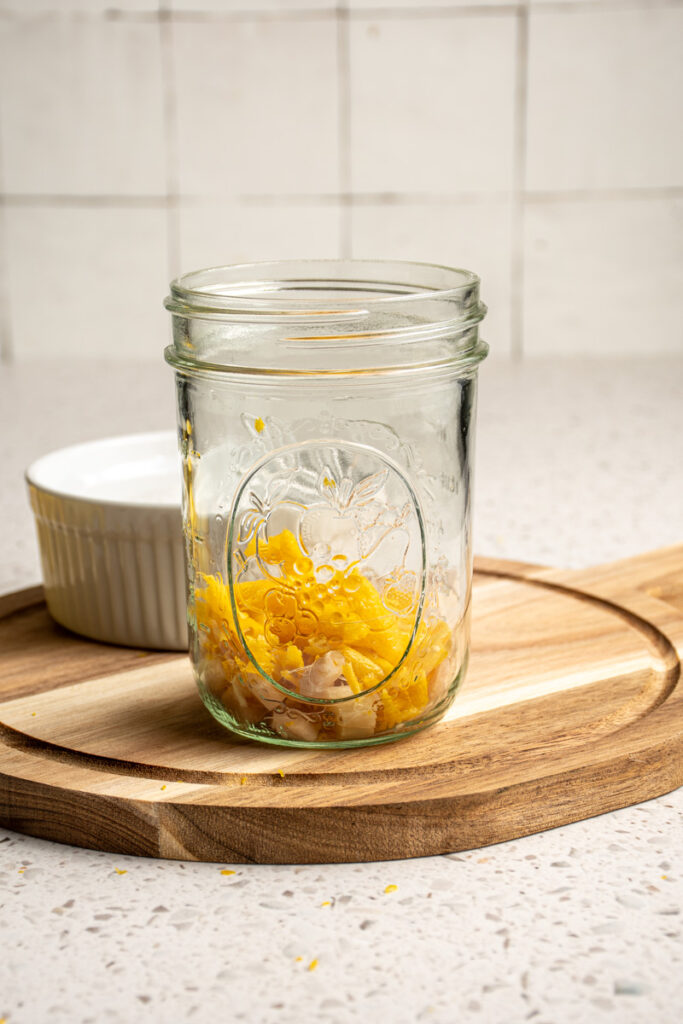 A jar with ginger and lemon zest.