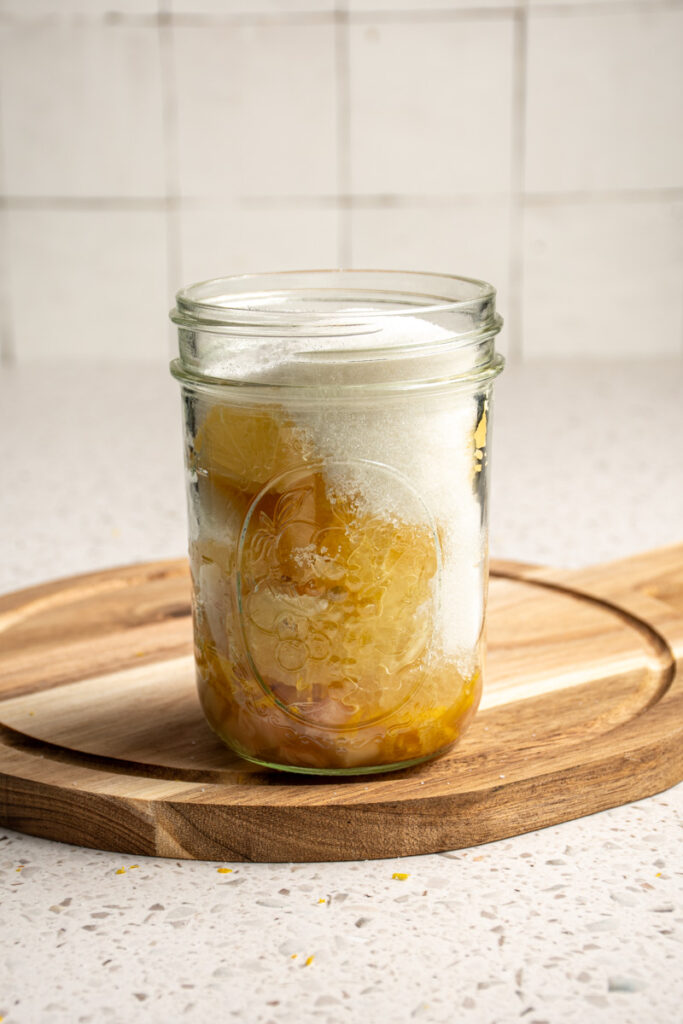 Jar with lemons, ginger, and sugar.
