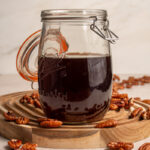 Pecan infused bourbon in a large glass jar.